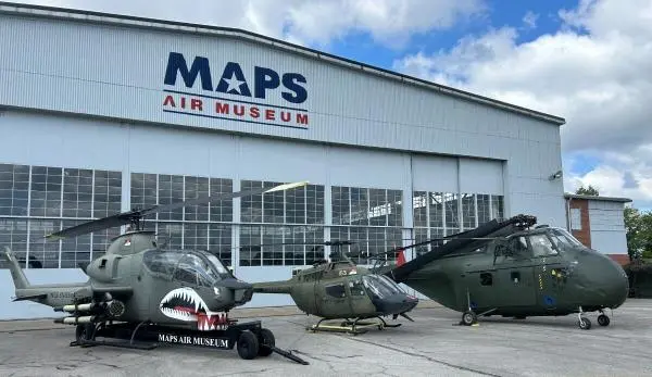 3 military hgelicopters outside the hanger at the MAPS Air Museum